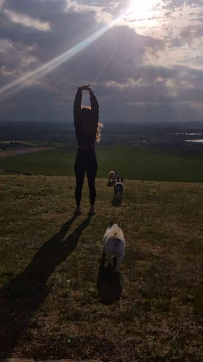 Angie out on a walk with the dogs at sunset