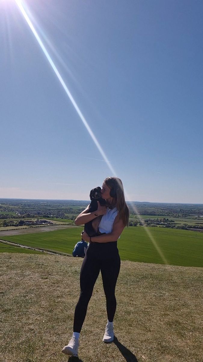Angie out walking with a dog on the hills